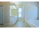 Bathroom showcases a large soaking tub and separate vanity area at 212 Terranova Blvd, Winter Haven, FL 33884