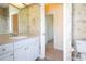 Bathroom with a single sink vanity, mirror, and wallpaper at 212 Terranova Blvd, Winter Haven, FL 33884