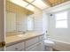 Well-lit bathroom features a shower-tub combo with updated vanity at 212 Terranova Blvd, Winter Haven, FL 33884