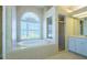 Elegant bathroom featuring a large soaking tub, a separate shower, and vanity area at 212 Terranova Blvd, Winter Haven, FL 33884