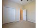Bright bedroom featuring a double door closet and doorway with trim at 212 Terranova Blvd, Winter Haven, FL 33884