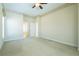 Spacious bedroom features plush carpeting and leads into an adjoining bathroom at 212 Terranova Blvd, Winter Haven, FL 33884