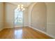 Charming dining room with hardwood floors, chandelier lighting, and window view at 212 Terranova Blvd, Winter Haven, FL 33884
