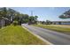 Entrance to community featuring a stone pillar sign and lush green grass at 212 Terranova Blvd, Winter Haven, FL 33884