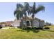 Beautiful single-Gathering home with mature palms, lush lawn, and a two-car garage at 212 Terranova Blvd, Winter Haven, FL 33884