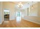 Open living room area with hardwood floors and access to a covered patio at 212 Terranova Blvd, Winter Haven, FL 33884