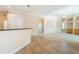 Open living room featuring adjacent kitchen, neutral walls, and oak cabinetry at 212 Terranova Blvd, Winter Haven, FL 33884