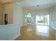Bright and open living room features hardwood floors, natural light, and a seamless flow to the pool area at 212 Terranova Blvd, Winter Haven, FL 33884