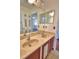 Bathroom featuring a double vanity with a marble countertop and framed mirrors reflecting the room at 2209 Pecos Ct, Poinciana, FL 34759