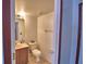 Simple bathroom with neutral tile, toilet, vanity, and medicine cabinet at 2209 Pecos Ct, Poinciana, FL 34759