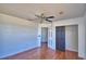 This bedroom features hardwood floors, a ceiling fan, and access to the closet at 2209 Pecos Ct, Poinciana, FL 34759