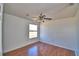 Bedroom featuring wood floors, a ceiling fan, and a bright window at 2209 Pecos Ct, Poinciana, FL 34759
