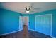 This bedroom features hardwood floors, a ceiling fan, and a closet for plenty of storage space at 2209 Pecos Ct, Poinciana, FL 34759