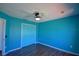 This bedroom features hardwood floors, a ceiling fan, and a closet for plenty of storage at 2209 Pecos Ct, Poinciana, FL 34759