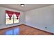 Bright bedroom featuring hardwood floors and a large window at 2209 Pecos Ct, Poinciana, FL 34759