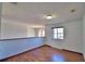 This hallway features hardwood floors, and natural light from a window at 2209 Pecos Ct, Poinciana, FL 34759