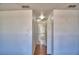 Hallway featuring neutral walls, laminate floors, and bathroom view at 2209 Pecos Ct, Poinciana, FL 34759