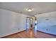This hallway features hardwood floors, with access to a bathroom at 2209 Pecos Ct, Poinciana, FL 34759