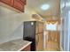 Functional laundry room with stainless steel refrigerator, shelving, washer, and dryer at 2209 Pecos Ct, Poinciana, FL 34759