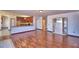 Spacious living room with hardwood floors and kitchen view at 2209 Pecos Ct, Poinciana, FL 34759