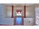 Living room featuring wood floors, decorative columns, and natural light at 2209 Pecos Ct, Poinciana, FL 34759
