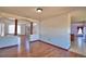 Open-concept living area featuring wood floors and decorative columns at 2209 Pecos Ct, Poinciana, FL 34759