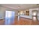 Spacious living room featuring hardwood floors with kitchen view at 2209 Pecos Ct, Poinciana, FL 34759