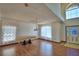 Spacious living room with wood floors, large windows, and elegant chandelier at 2209 Pecos Ct, Poinciana, FL 34759