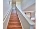 Staircase with laminate floors, leading to a bright, open upper level at 2209 Pecos Ct, Poinciana, FL 34759