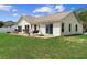 Large backyard featuring a paved patio with seating and a swing, perfect for outdoor enjoyment at 2645 Debany Rd, Kissimmee, FL 34744