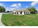 Spacious backyard with a swing, patio furniture, and a well-maintained lawn at 2645 Debany Rd, Kissimmee, FL 34744