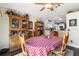 Traditional dining room with wood floors, dining hutch, and a view into the kitchen at 2645 Debany Rd, Kissimmee, FL 34744