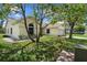 Quaint home with a well-manicured lawn and mature trees providing shade at 2645 Debany Rd, Kissimmee, FL 34744