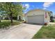 Home with a large two-car garage, well-maintained landscaping, and a welcoming facade at 2645 Debany Rd, Kissimmee, FL 34744