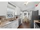 Bright kitchen featuring white cabinets, granite countertops, stainless steel appliances, and a cozy breakfast nook at 2645 Debany Rd, Kissimmee, FL 34744