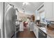 Galley kitchen featuring stainless steel appliances, granite countertops, white cabinetry, and pass-through to dinette at 2645 Debany Rd, Kissimmee, FL 34744
