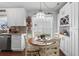 Bright kitchen nook features built-in wine rack and a view into the kitchen with stainless steel appliances and white cabinets at 2645 Debany Rd, Kissimmee, FL 34744