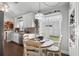 Cozy kitchen nook featuring a round wooden table with views into kitchen with stainless steel appliances and white cabinets at 2645 Debany Rd, Kissimmee, FL 34744