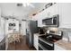 A well-equipped kitchen with stainless steel appliances, granite countertops, and white cabinetry and breakfast nook at 2645 Debany Rd, Kissimmee, FL 34744