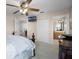 Comfortable bedroom featuring a ceiling fan, TV, closet, and attached bathroom view at 2712 Lido Key Dr, Kissimmee, FL 34747