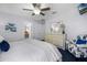Relaxing bedroom featuring a bed with blue accents, a dresser, and closet doors at 2712 Lido Key Dr, Kissimmee, FL 34747