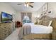 Bright bedroom featuring a ceiling fan, neutral walls, and decorative furniture at 2712 Lido Key Dr, Kissimmee, FL 34747