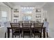 Stylish dining room with a long table, elegant lighting, and built-in shelves, blending charm and functionality at 2712 Lido Key Dr, Kissimmee, FL 34747