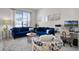 Comfortable living room with bright window and a pair of blue sofas for the perfect gathering space at 2712 Lido Key Dr, Kissimmee, FL 34747