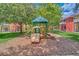 Community playground surrounded by lush greenery for outdoor fun with slides, climbing structures, and open space at 2712 Lido Key Dr, Kissimmee, FL 34747