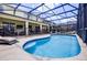 Backyard pool with a screened enclosure and outdoor lounge area at 2712 Lido Key Dr, Kissimmee, FL 34747