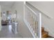 Bright, inviting staircase features hardwood steps and a white railing, adding a touch of elegance to the home's interior at 2712 Lido Key Dr, Kissimmee, FL 34747