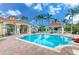 Community swimming pool with sparkling clear water, poolside seating, and a covered snack bar at 2712 Lido Key Dr, Kissimmee, FL 34747