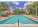 Enjoy this community pool with clear blue water, poolside seating, and a covered snack bar under a tropical setting at 2712 Lido Key Dr, Kissimmee, FL 34747