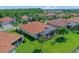 Aerial view showcasing a home with a well-manicured lawn, screened-in patio, and tile roof at 2721 Swoop Cir, Kissimmee, FL 34741